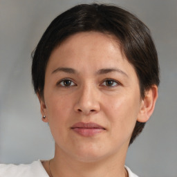 Joyful white adult female with short  brown hair and brown eyes