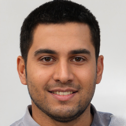 Joyful white young-adult male with short  black hair and brown eyes
