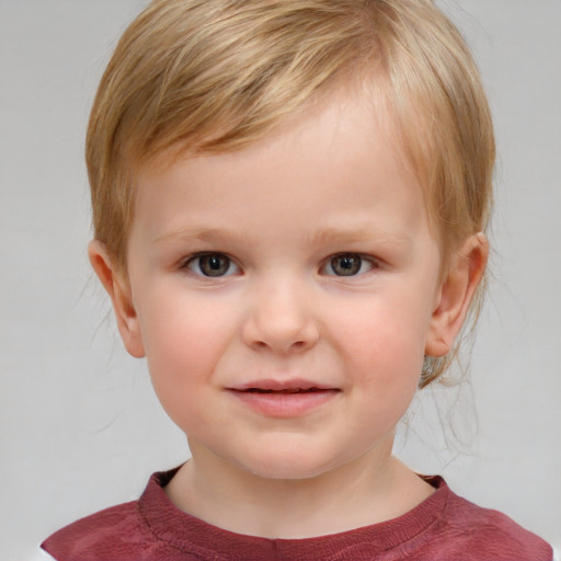 Joyful white child male with medium  brown hair and blue eyes