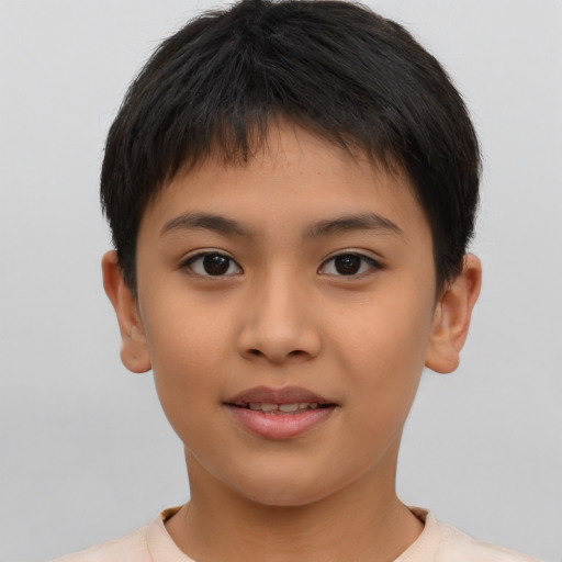 Joyful latino child male with short  brown hair and brown eyes