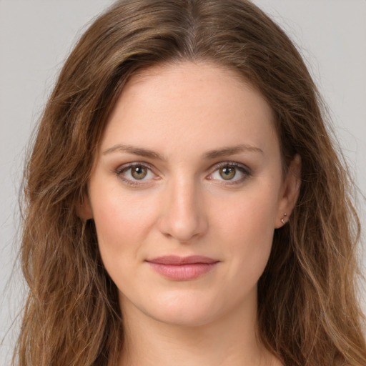 Joyful white young-adult female with long  brown hair and green eyes