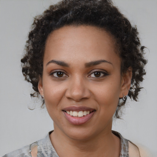 Joyful black young-adult female with medium  brown hair and brown eyes