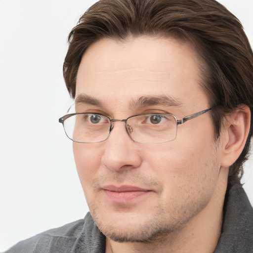 Joyful white adult male with short  brown hair and brown eyes