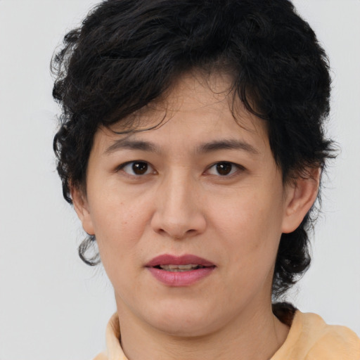 Joyful asian adult female with short  brown hair and brown eyes