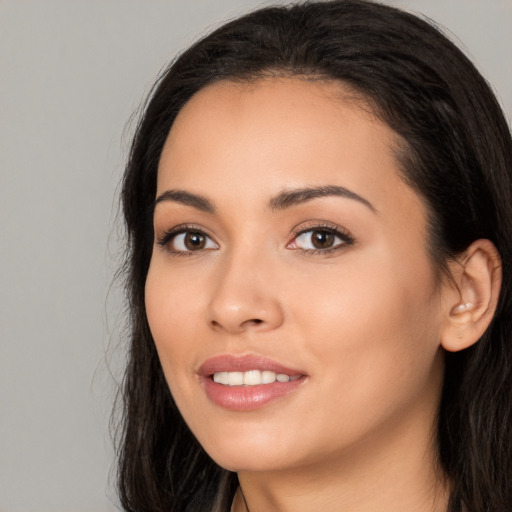 Joyful white young-adult female with long  black hair and brown eyes