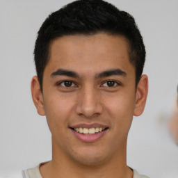 Joyful latino young-adult male with short  brown hair and brown eyes