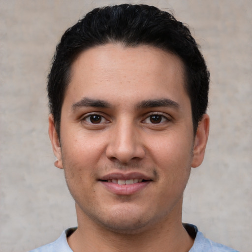 Joyful white young-adult male with short  black hair and brown eyes