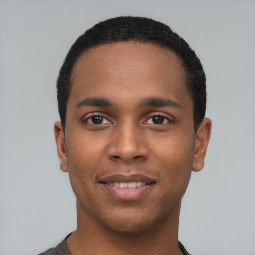 Joyful black young-adult male with short  black hair and brown eyes