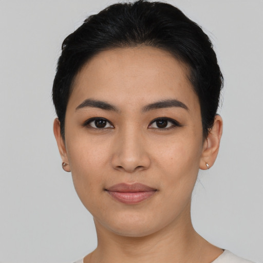 Joyful asian young-adult female with short  black hair and brown eyes