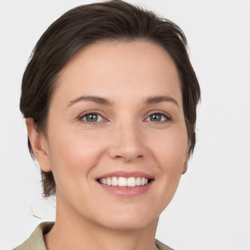 Joyful white young-adult female with short  brown hair and grey eyes