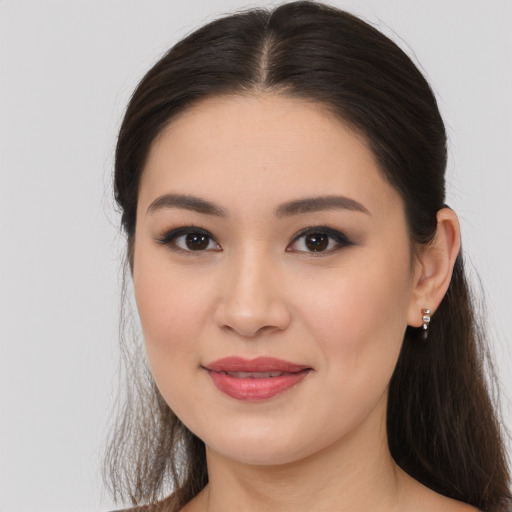 Joyful white young-adult female with long  brown hair and brown eyes