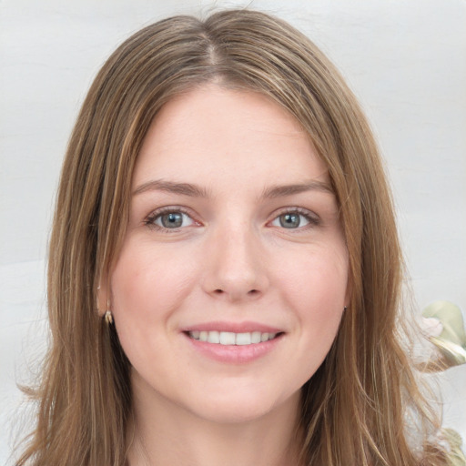 Joyful white young-adult female with long  brown hair and green eyes