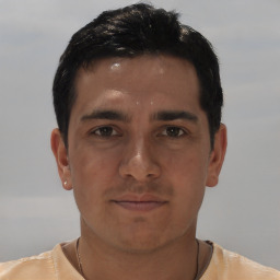 Joyful white young-adult male with short  black hair and brown eyes
