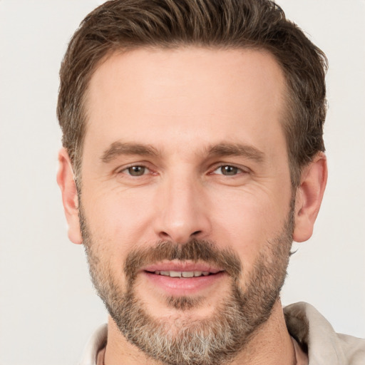 Joyful white adult male with short  brown hair and brown eyes