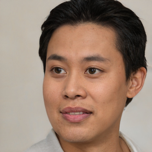 Joyful asian young-adult male with short  brown hair and brown eyes