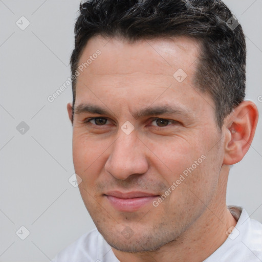 Joyful white adult male with short  brown hair and brown eyes