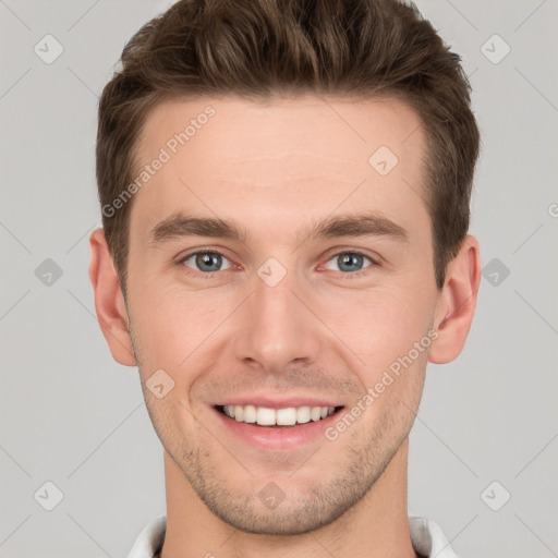 Joyful white young-adult male with short  brown hair and grey eyes