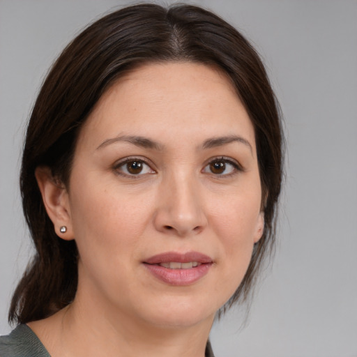 Joyful white young-adult female with medium  brown hair and brown eyes