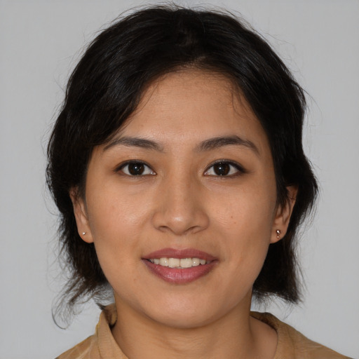 Joyful asian young-adult female with medium  brown hair and brown eyes