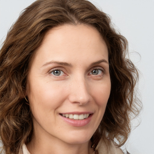 Joyful white young-adult female with medium  brown hair and green eyes