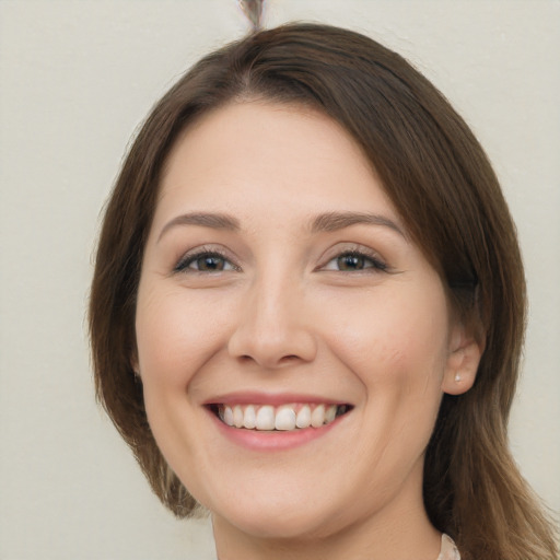 Joyful white young-adult female with long  brown hair and brown eyes