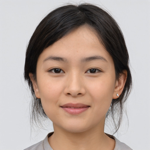 Joyful asian young-adult female with medium  brown hair and brown eyes