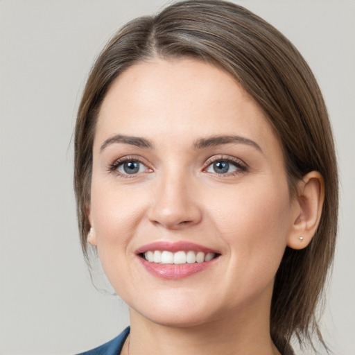 Joyful white young-adult female with medium  brown hair and grey eyes