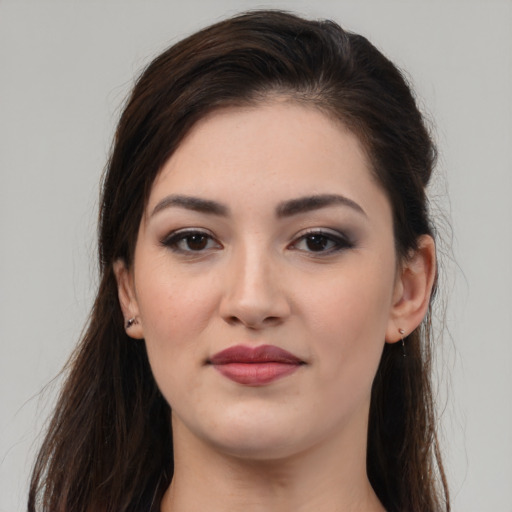 Joyful white young-adult female with long  brown hair and brown eyes