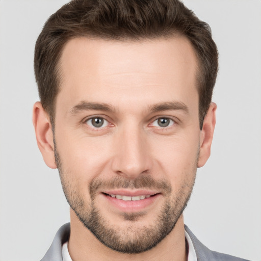 Joyful white young-adult male with short  brown hair and brown eyes