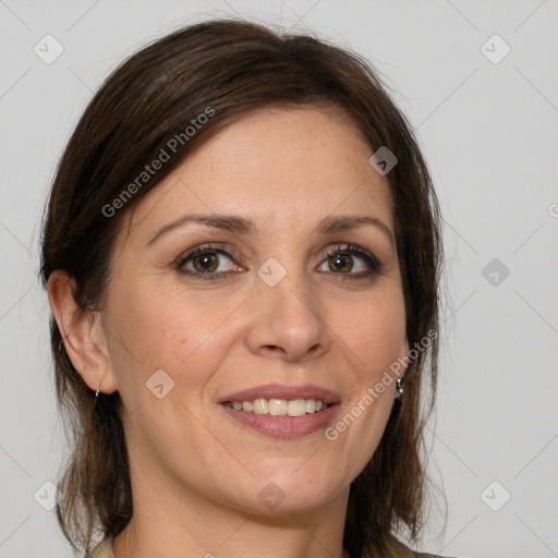 Joyful white adult female with medium  brown hair and grey eyes