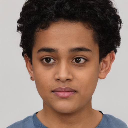 Joyful latino child male with short  brown hair and brown eyes