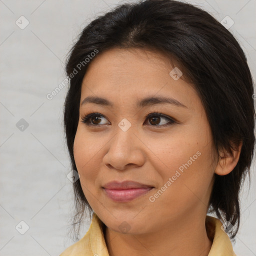 Joyful latino young-adult female with medium  brown hair and brown eyes