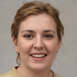 Joyful white young-adult female with medium  brown hair and grey eyes