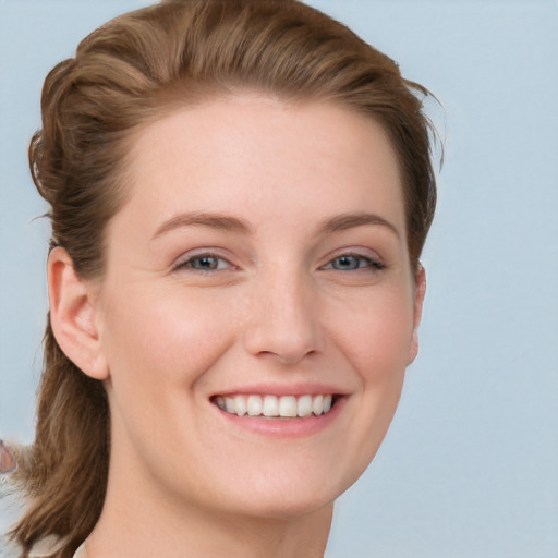 Joyful white young-adult female with long  brown hair and blue eyes