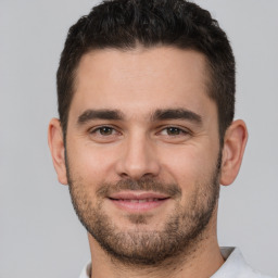 Joyful white young-adult male with short  brown hair and brown eyes