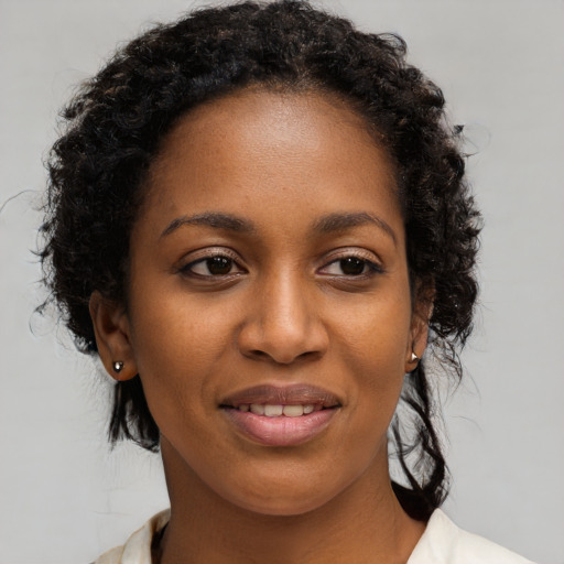Joyful black young-adult female with medium  brown hair and brown eyes