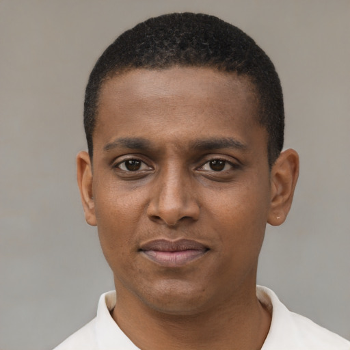 Joyful black young-adult male with short  black hair and brown eyes
