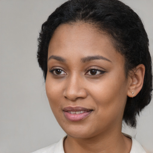 Joyful black young-adult female with medium  black hair and brown eyes