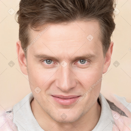 Joyful white adult male with short  brown hair and grey eyes