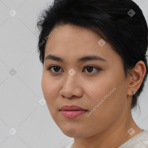 Joyful latino young-adult female with short  black hair and brown eyes