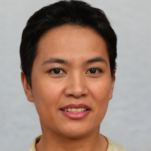 Joyful asian young-adult female with short  brown hair and brown eyes
