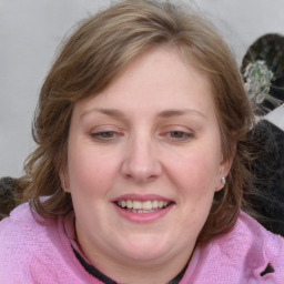 Joyful white young-adult female with medium  brown hair and blue eyes