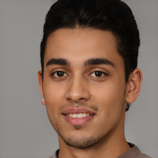 Joyful white young-adult male with short  black hair and brown eyes