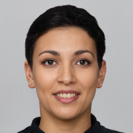 Joyful latino young-adult female with short  black hair and brown eyes