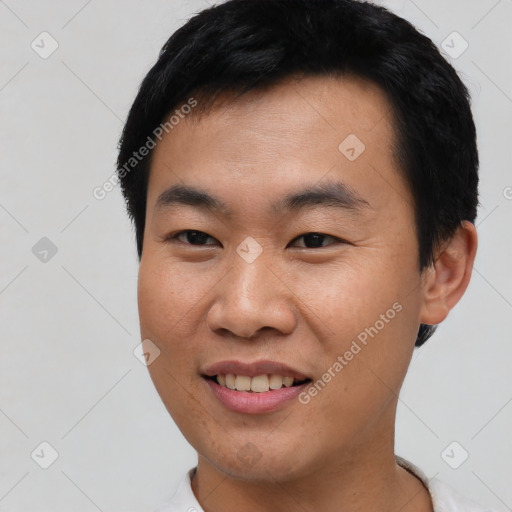 Joyful asian young-adult male with short  black hair and brown eyes