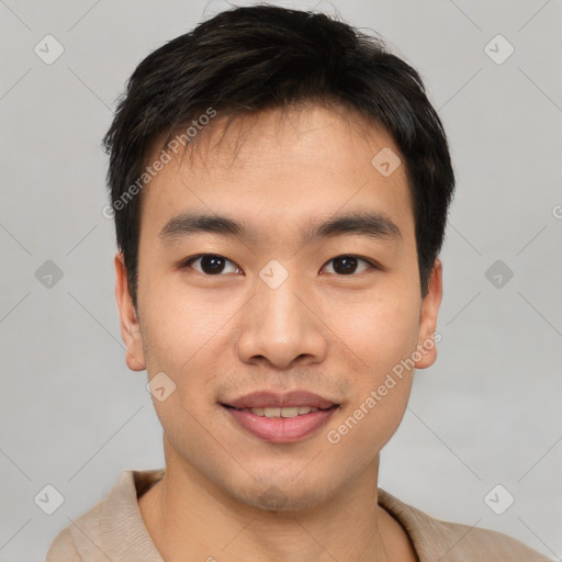 Joyful asian young-adult male with short  black hair and brown eyes