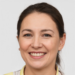 Joyful white adult female with medium  brown hair and brown eyes