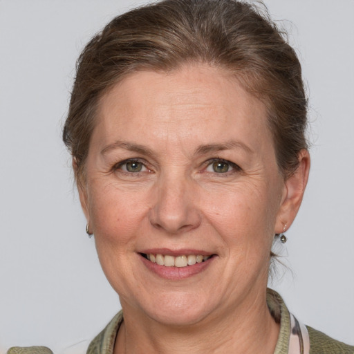 Joyful white adult female with medium  brown hair and grey eyes