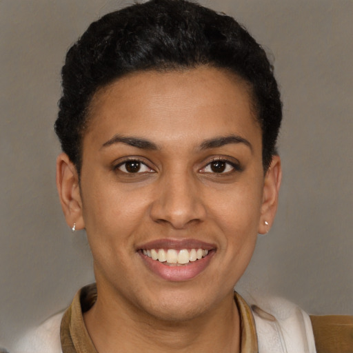 Joyful latino young-adult female with short  brown hair and brown eyes