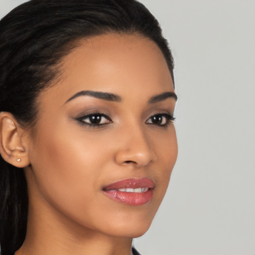 Joyful latino young-adult female with long  brown hair and brown eyes